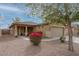 Charming single-story home featuring desert landscaping, a two-car garage and vibrant blooming shrubs at 25067 W Dove Trl, Buckeye, AZ 85326