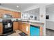 A functional kitchen featuring wood cabinets, granite countertops, stainless steel appliances, and tile flooring at 25067 W Dove Trl, Buckeye, AZ 85326