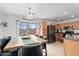 An eat-in kitchen featuring wood cabinets, stainless steel appliances, tile flooring, and a sliding glass door at 25067 W Dove Trl, Buckeye, AZ 85326