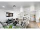 Bright living room with comfortable seating, neutral tones, and ample natural light streaming through the window at 25067 W Dove Trl, Buckeye, AZ 85326