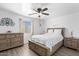 A primary bedroom featuring wood floors, ceiling fan, and neutral walls at 25067 W Dove Trl, Buckeye, AZ 85326