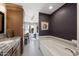 Bathroom with large tub, neutral tile, and dark purple accent wall at 2585 Leisure World --, Mesa, AZ 85206