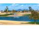 Scenic golf course view, complete with lush greenery, a tranquil pond, and distant mountain views at 2585 Leisure World --, Mesa, AZ 85206