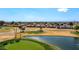 Scenic golf course view showcasing putting green, blue sky, pond, and mature landscaping at 2585 Leisure World --, Mesa, AZ 85206