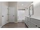 The bathroom features a white vanity, quartz countertops, a shower and bathtub combo, and neutral walls at 25872 W Hilton Ave, Buckeye, AZ 85326