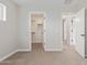 Bedroom featuring neutral carpet and doors that lead to the closet and other rooms at 25872 W Hilton Ave, Buckeye, AZ 85326