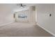 A large bedroom featuring carpet flooring, neutral walls, and a ceiling fan at 25872 W Hilton Ave, Buckeye, AZ 85326