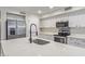 Close up on the kitchen island with stainless steel appliances, white cabinets, and light countertops at 25872 W Hilton Ave, Buckeye, AZ 85326