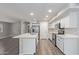 Bright kitchen with a large island, stainless steel appliances, quartz countertops, and white cabinets at 25872 W Hilton Ave, Buckeye, AZ 85326