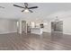 Open-concept living space with kitchen island, stainless appliances and new flooring at 25872 W Hilton Ave, Buckeye, AZ 85326