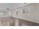 Living room with large windows and ceiling fan, with light-colored walls and new laminate floors at 25872 W Hilton Ave, Buckeye, AZ 85326