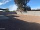 The backyard is covered in gravel and has a large concrete block wall at 2632 E Irwin Ave, Mesa, AZ 85204