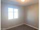 Bright bedroom features carpet floors, neutral paint, and a window at 2632 E Irwin Ave, Mesa, AZ 85204