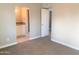 This bedroom has a connected bathroom and an open door to another room at 2632 E Irwin Ave, Mesa, AZ 85204