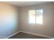 Cozy bedroom with plush carpeting, neutral walls, and a window with natural light at 2632 E Irwin Ave, Mesa, AZ 85204