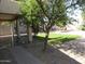 Serene backyard featuring a covered patio, rock landscaping, and greenery at 2830 W Grenadine Rd, Phoenix, AZ 85041