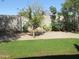 Landscaped backyard boasts lush grass and a block fence for privacy at 2830 W Grenadine Rd, Phoenix, AZ 85041