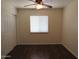 Comfortable bedroom featuring wood-look floors, ceiling fan, and a large window at 2830 W Grenadine Rd, Phoenix, AZ 85041