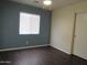 Bedroom with wood floors and a large window at 2830 W Grenadine Rd, Phoenix, AZ 85041