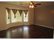 Bedroom with hardwood floors, large bay window with curtains, and a ceiling fan at 2830 W Grenadine Rd, Phoenix, AZ 85041