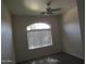 Bedroom features a ceiling fan and a large window for natural light at 2830 W Grenadine Rd, Phoenix, AZ 85041