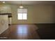 Dining area with a window for natural light and transitions to a dark hardwood floor at 2830 W Grenadine Rd, Phoenix, AZ 85041