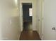 Hallway showcasing tile floors and neutral paint with a view into another room at 2830 W Grenadine Rd, Phoenix, AZ 85041