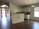 Bright kitchen features white cabinets, tile backsplash, and an island with decorative tile work at 2830 W Grenadine Rd, Phoenix, AZ 85041