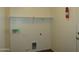 Bright laundry room with shelving, hookups, and a pet door at 2830 W Grenadine Rd, Phoenix, AZ 85041