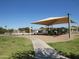 Enjoy the neighborhood playground with shade covering, surrounded by green grass and concrete sidewalks at 2830 W Grenadine Rd, Phoenix, AZ 85041