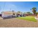 Spacious backyard featuring artificial turf, a covered patio, and a low-maintenance gravel area at 3028 E Highland Ave, Phoenix, AZ 85016