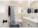 Bright bathroom featuring shower-tub, updated vanity and mirror at 3028 E Highland Ave, Phoenix, AZ 85016