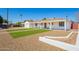 Home exterior with white paint, desert landscaping, a strip of grass and covered porch at 3028 E Highland Ave, Phoenix, AZ 85016