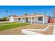 Home exterior with white paint, desert landscaping, a strip of grass and covered porch at 3028 E Highland Ave, Phoenix, AZ 85016