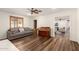 Living room featuring a gray sofa, piano, and wood-look flooring at 3028 E Highland Ave, Phoenix, AZ 85016