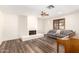 A bright living room features a fireplace, ceiling fan, and stylish wood-look floors at 3028 E Highland Ave, Phoenix, AZ 85016