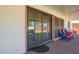 Patio door with adjacent colorful chairs on a covered patio, transitioning between indoor and outdoor spaces at 3028 E Highland Ave, Phoenix, AZ 85016