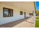 Covered front porch with view of window, door, desert landscaping and a strip of grass at 3028 E Highland Ave, Phoenix, AZ 85016