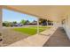 Covered front porch view of home's manicured lawn, desert landscaping, and street at 3028 E Highland Ave, Phoenix, AZ 85016