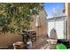 Cozy backyard featuring a Blackstone grill, storage shed, privacy walls, and a neutral-toned patio umbrella at 3541 E Amber Ln, Gilbert, AZ 85296