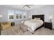 Bedroom with a ceiling fan and natural light coming in from the white-shuttered windows at 3541 E Amber Ln, Gilbert, AZ 85296