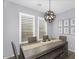 Elegant dining room with a modern chandelier and shuttered windows providing natural light at 3541 E Amber Ln, Gilbert, AZ 85296