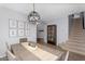 Elegant dining room with a modern chandelier, stylish decor, and adjacent staircase at 3541 E Amber Ln, Gilbert, AZ 85296