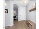 Inviting entryway with light gray walls, decorative shelf, wood-look flooring, and a bench at 3541 E Amber Ln, Gilbert, AZ 85296