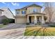 Charming two-story home featuring a two-car garage, stone accents, and a welcoming front porch at 3541 E Amber Ln, Gilbert, AZ 85296