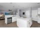 Open kitchen with a white quartz island, stainless appliances, and seamless transition to the living room at 3541 E Amber Ln, Gilbert, AZ 85296