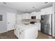 Spacious kitchen with white cabinetry, stainless steel appliances, and a large central island at 3541 E Amber Ln, Gilbert, AZ 85296