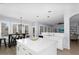 Well-lit kitchen with white cabinets, modern island, and an adjacent dining area with large windows at 3541 E Amber Ln, Gilbert, AZ 85296