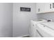 Bright laundry room with white washer and dryer machines at 3541 E Amber Ln, Gilbert, AZ 85296