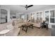 Bright living room featuring plantation shutters, wood-look tile floors, and neutral furnishings at 3541 E Amber Ln, Gilbert, AZ 85296